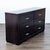 This sleek dresser features a dark wood finish and six spacious drawers. The silver handles add a modern touch, making it...