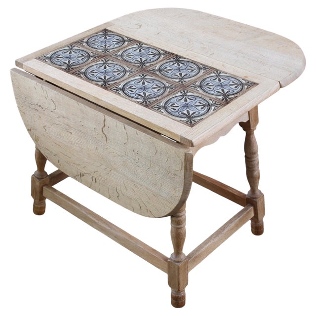 This charming folding coffee table pairs traditional craftsmanship with thoughtful, space-saving design. Crafted from...