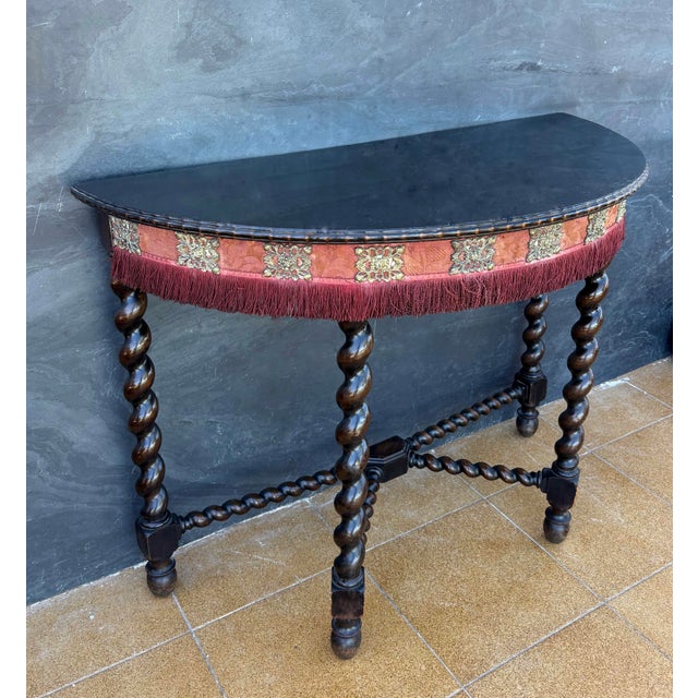 Striking Spanish Baroque style demilune console table dating to the early 20th century. The table features a semi-circular...