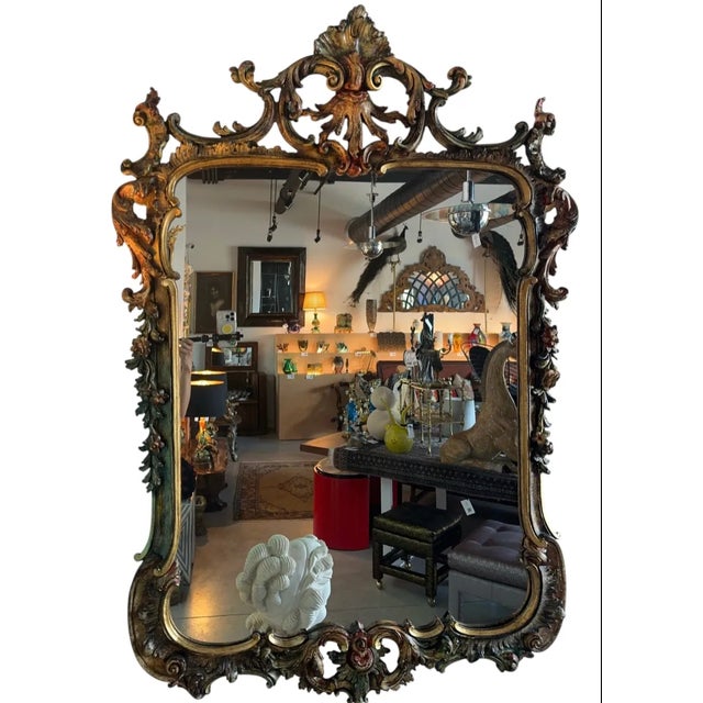 35”W x 53 1/2”H x 3 1/2”D This hand-carved wall mirror presents a compelling study in the principles of the Italian Rococo...
