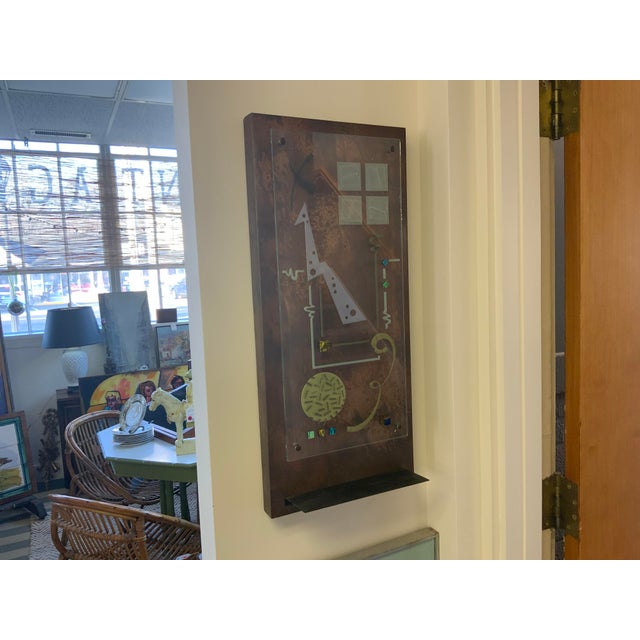 Artist Selena Mixed Media wall art. Abstract design using glass, copper, paint as well as a small shelf at the bottom.