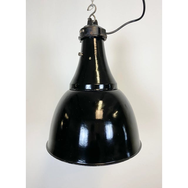 Vintage industrial black enamel pendant lamp in Bauhaus style. Used in factories in the former Czechoslovakia during the...