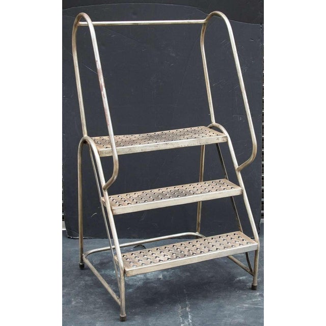 An English industrial step ladder of sturdy steel construction. Each step has perforations making a nice tiered plant...
