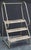 An English industrial step ladder of sturdy steel construction. Each step has perforations making a nice tiered plant...
