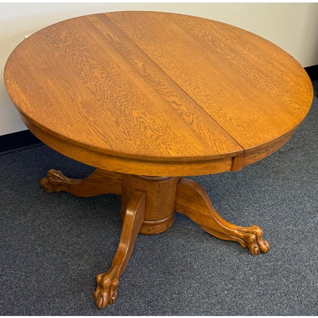 Beautiful vintage oak round pedestal dining table featuring a rich golden oak finish and stunning natural wood grain. The...