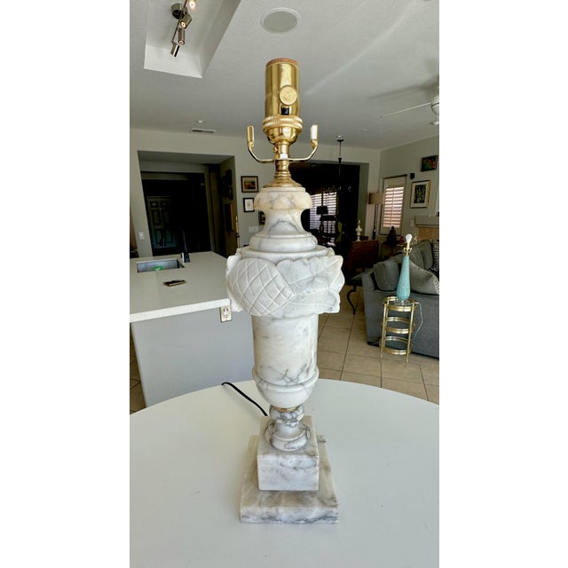 Single vintage Italian Neoclassical style table lamp made from hand-carved alabaster, featuring a floral carved band on...