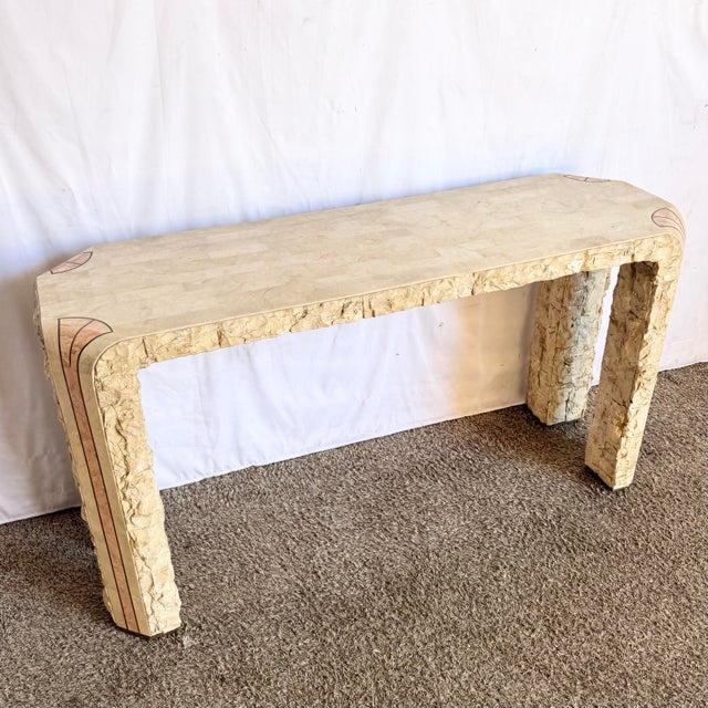 Sculptural postmodern console table crafted in tessellated beige stone, accented with subtle pink stone detailing and...