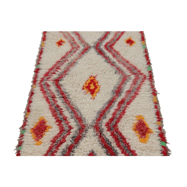 Hand-knotted in wool and originating from Morocco circa 1950-1960, this 3x6 vintage Moroccan rug is an extremely rare...