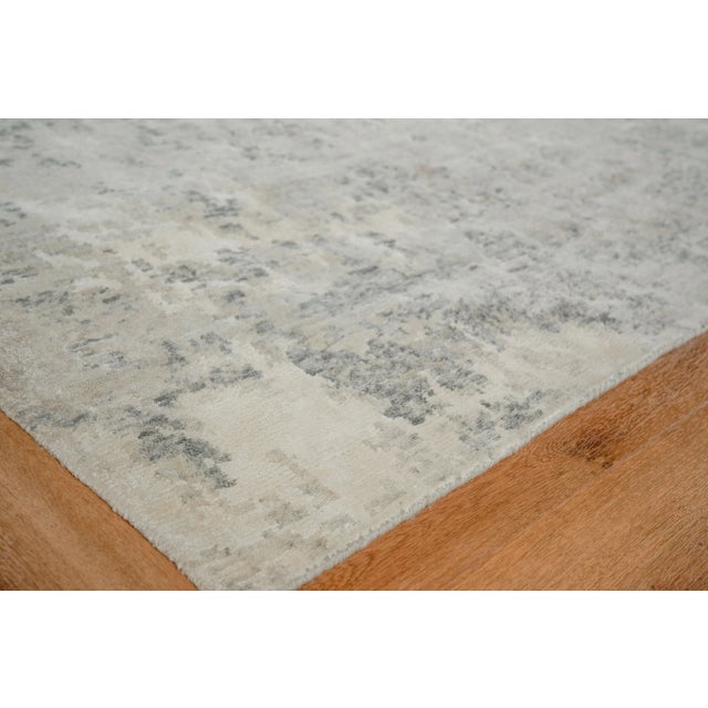 The Cosmo rug is hand knotted and artfully designed of wool and shimmering accents of Bamboo Silk. This remarkable...
