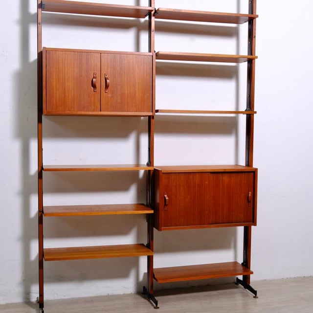 Beautiful teak bookcase, Scandinavian style, elegant and refined, with precious curved wood handle details. Well...