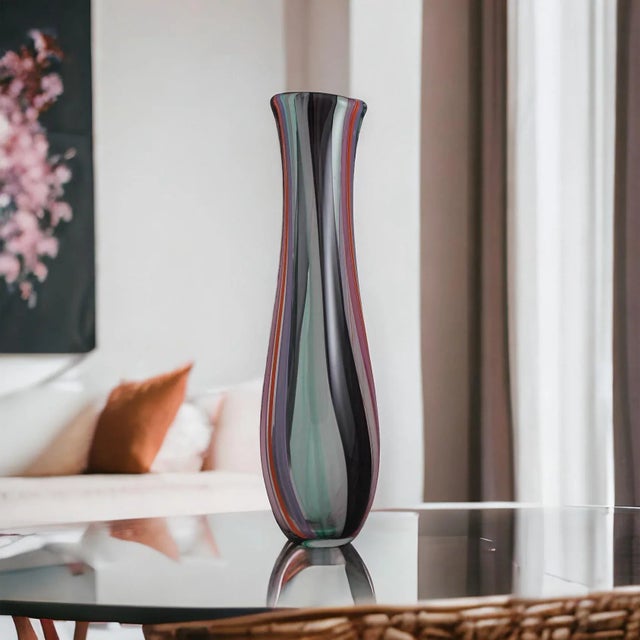 A beautiful Hand-Blown Glass Vase. Elevate your space with this exquisite hand-blown glass vase, meticulously crafted in a...