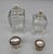A matched pair of antique crystal scent bottles with silver collars and lids. The crystal bodies feature a beautifully cut...