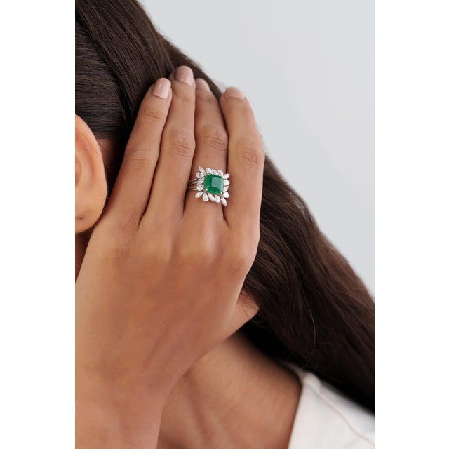 This floral cocktail ring features a 2.85 carat emerald and diamond, set in 18k white gold. The center stone measuring...