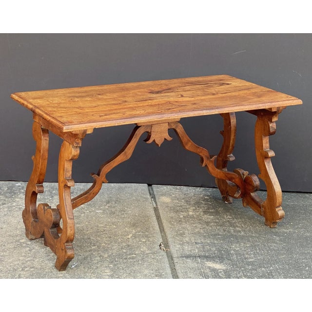 A handsome Italian table or Fratino table of walnut, in the Baroque style, featuring a rectangular plank top over turned...