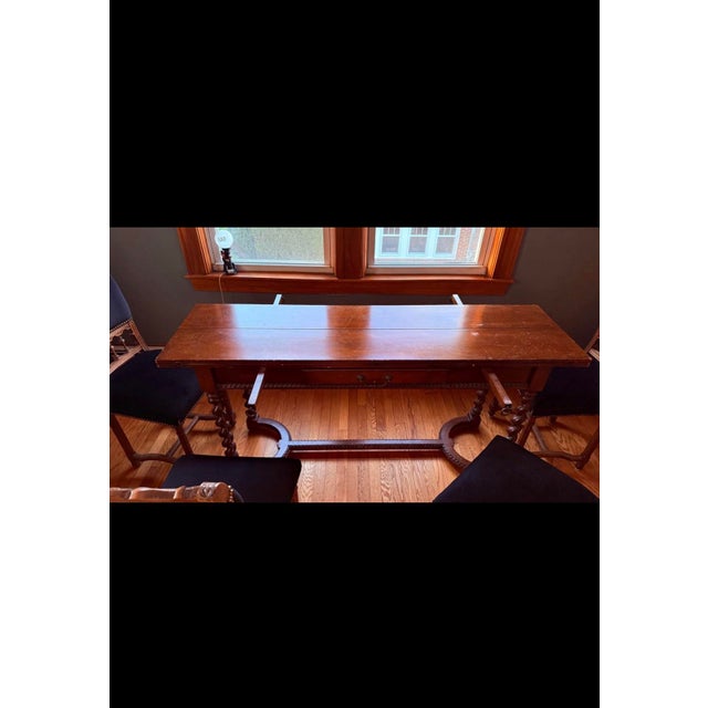The table is an antique Spanish refectory-style dining table or desk, likely dating from the 18th or 19th century. Key...