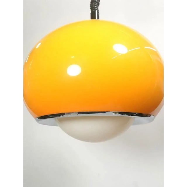 Mid-century modern Meblo drop light by Guzzini. The orange variation (this color) is said to be the best looking version...