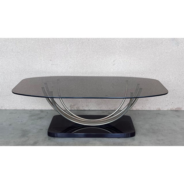 Amazing side or coffee table with curved chrome pedestal leg and the base of the table is made of ebonizd wood. The smoked...
