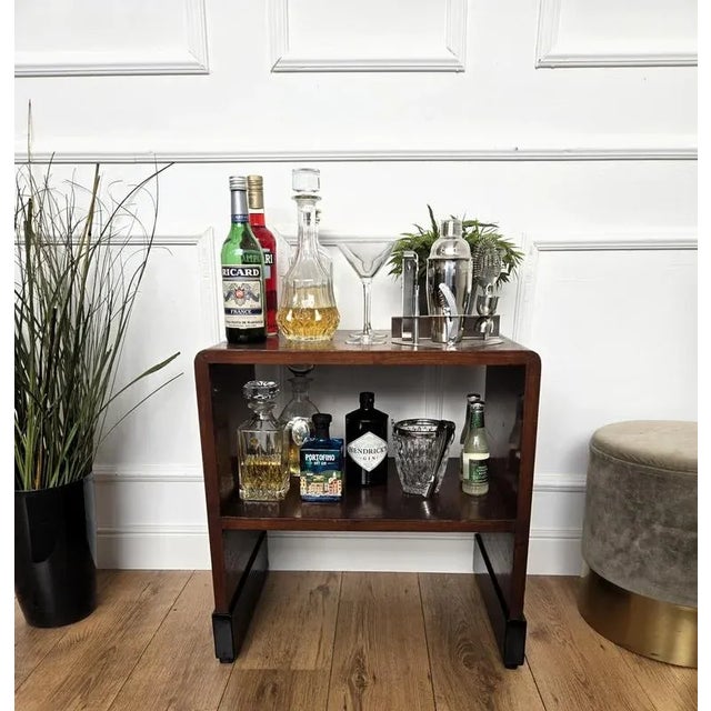 Very elegant Italian side table in typical Art Deco shape and materials with its beautiful wood and the overall harmonic...