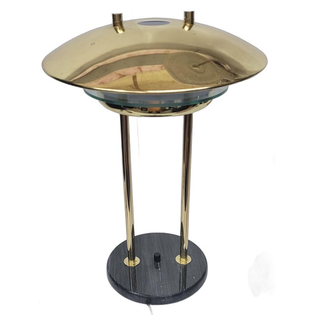 An postmodern flying saucer table lamp in style of Robert Sonneman. Marble base, Chrome brass shade. Works great and has a...