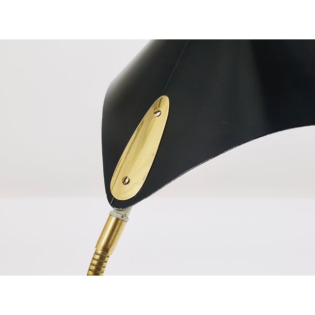 A beautiful Mid-Century modern Stilnovo-Style „Cobra“ table or desk lamp from the 1950s, executed by the German...