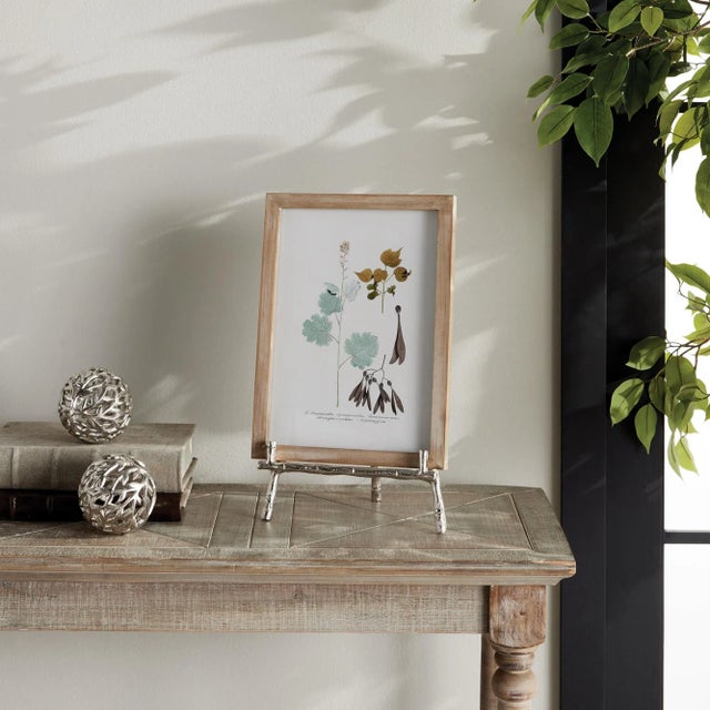 Made to hold platters, cookbooks or a small piece of art, this easel is strong and sturdy. The silver bamboo-like details...