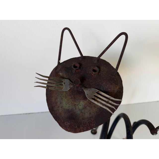 Charming vintage handmade folk art cat sculpture crafted from welded metal elements, showcasing a playful and whimsical...