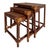 These are vintage McGuire Manner rattan nesting tables featuring rawhide-wrapped corners and woven grass cloth tops....