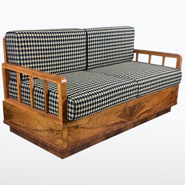 This Art-Deco sofa from the 1930s features a strong architectural wooden frame combined with newly upholstered cushions in...