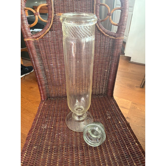 Distinctive antique swirled glass pattern on the neck and lid finial. This item is an antique Columbia Swirl pharmacy...