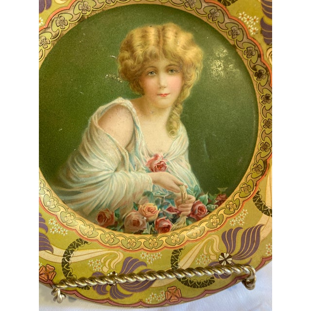 A rare and beautiful Royal Saxony “Flower Girl” decorative metal plate, produced exclusively by the Chas W. Shonk Co. of...
