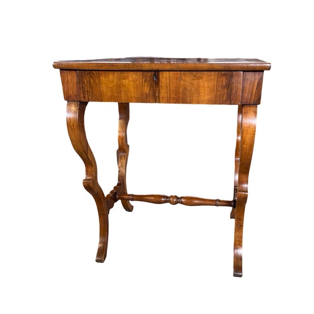 Side table hand-made in Italy in the early 1800s using walnut and decorated with book-matched walnut veneer. The side...