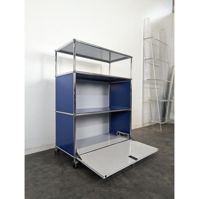 Gentian Blue and White Cabinet with Drop-Down Door on Casters from USM Haller, in Very Good conditions.