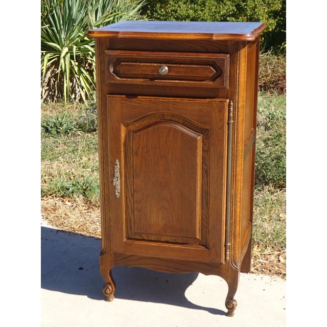 Rustic french-made jam cupboard from the 1980s, crafted from oak and dark oak veneer. simple sideboard with one door and...