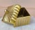 Here is a decorative yet functional home accessory in a warm gold color, square in form, widening toward the top, with a...