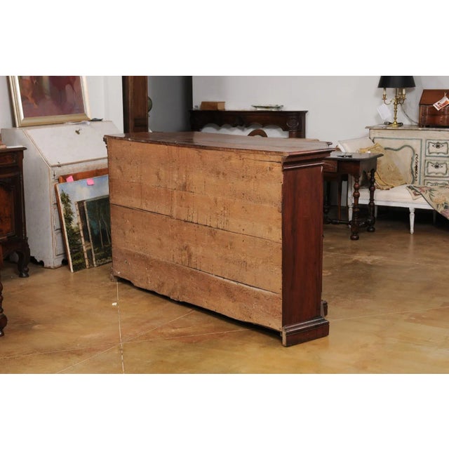 An Italian walnut dresser from the 17th century with four drawers, protruding front, canted sides with doors, bronze...