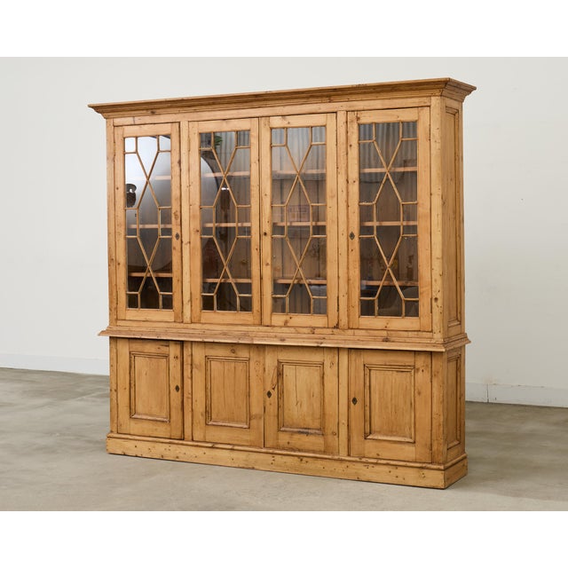 Large 19th century country English pine bibliotheque or bookcase cabinet made in the George III taste. The bookcase...