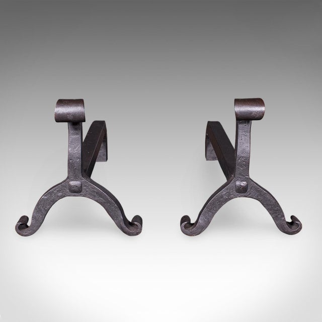 This is a long pair of antique firedogs. An English, estate made wrought iron fireplace andiron, dating to the Victorian...