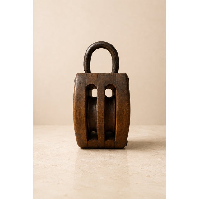 There are objects that are not merely tools, but true witnesses of history. This antique nautical double pulley block,...