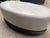 Baker ivory leather oval ottoman designed by Barbara Barry