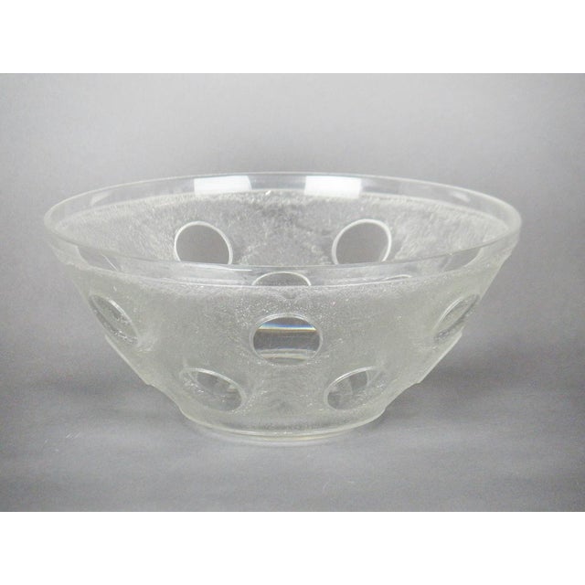 A clear, rounded white bowl decorated with acid-etched lozenges. Signed Daum Nancy France. This piece has an attribution...
