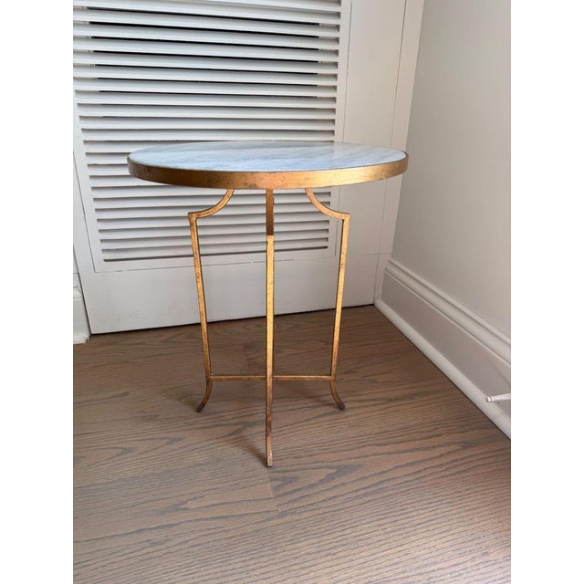 Versitile side table with a white and gray granite top sitting upon a weathered brass base. 16.5”W x 16.5”D x 19.75”H