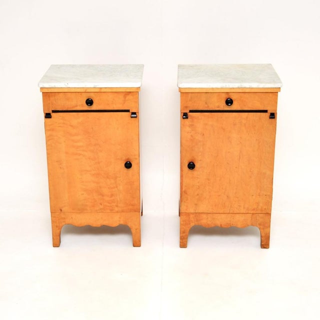 A beautiful pair of antique Swedish satin birch marble top bedside cabinets. They were recently imported from Sweden, they...