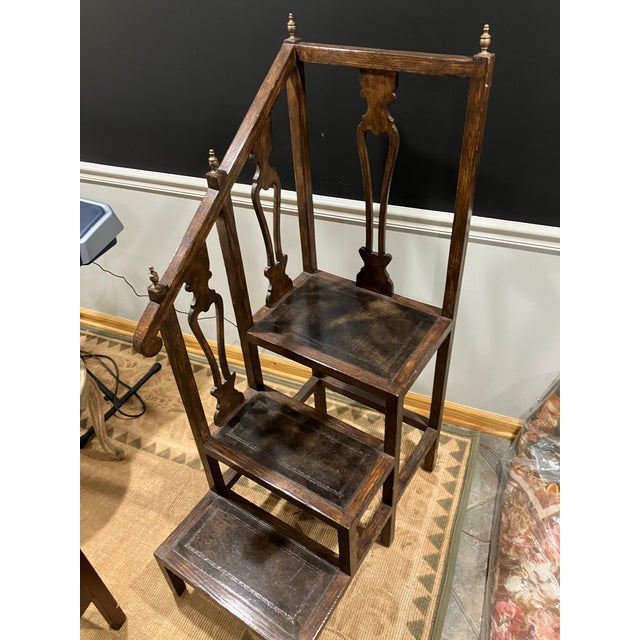 A late 19th century freestanding library step constructed in oak. The piece has three steps integrated into a single body....