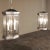 Pair Mid-Century Brushed Steel Lantern Chandeliers were crafted in an octagonal design with beveled glass on each facet,...