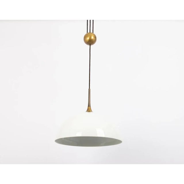Large adjustable dark brass counterweight pendant light designed by florian schulz, germany, 1970s. It is a masterpiece of...