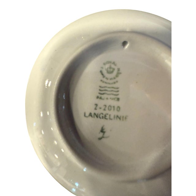 Back of plate has blurry printing, but says: Royal Copenhagen Denmark (logo) Fajance 2-2010 Langelinie Signature