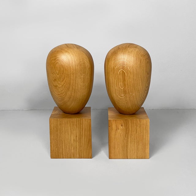 Italian postmodern stylized head sculptures in wood, 1990s Pair of sculptures made entirely of wood. The upper part is...