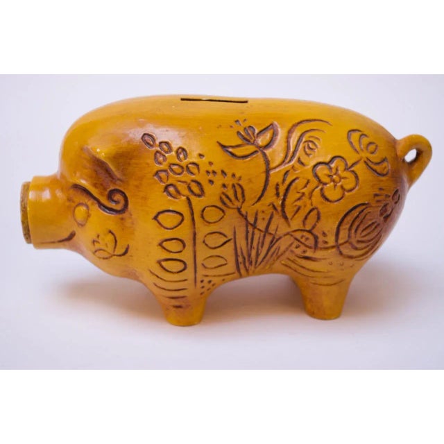 Circa 1960s California Pottery 'piggy' bank with incised floral motif throughout. Lovely golden yellow color with the...