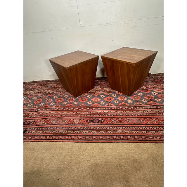 Elevate your space with bold geometry and rich woodgrain. This pair of vintage mahogany storage side tables offers a...