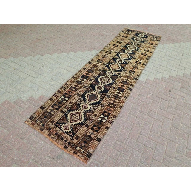 This beautiful, traditional vintage, flatweaved Turkish runner is approximately 60 years old. It is handmade of very fine...